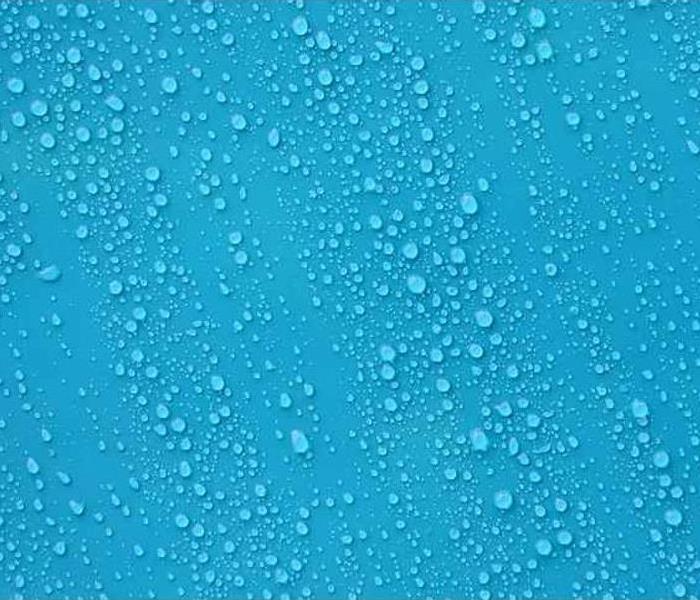 Water droplets against a light blue background