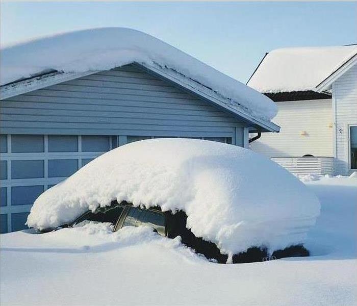 snow covered house and car