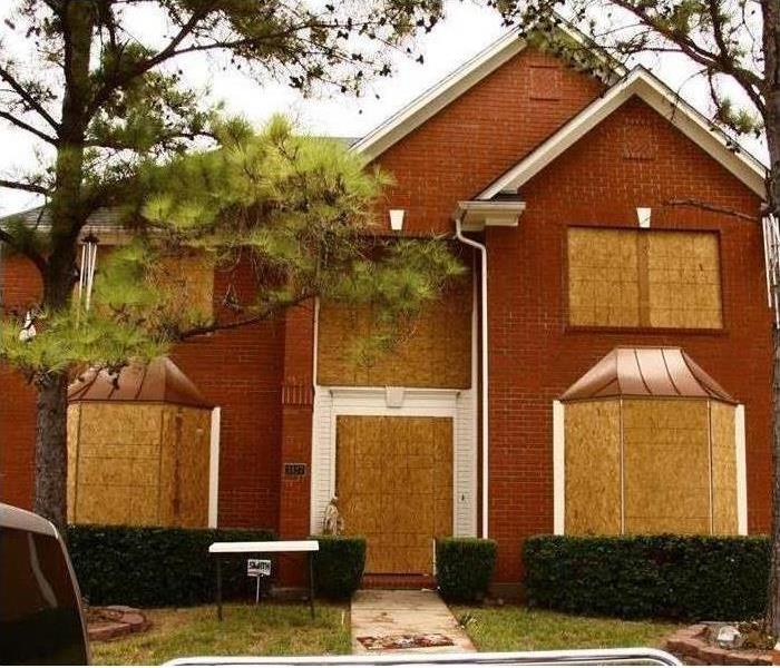boarded up house after storm